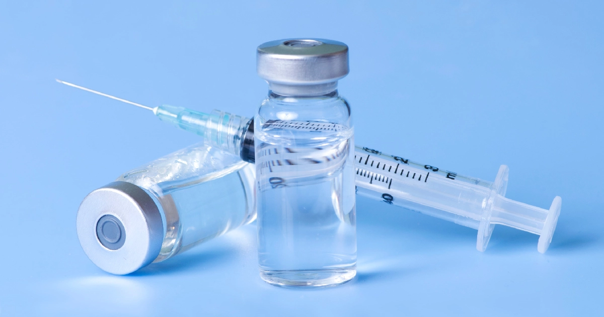 Close-up of clear vials and a syringe filled with solution, representing Vitamin Injections in Brea, CA